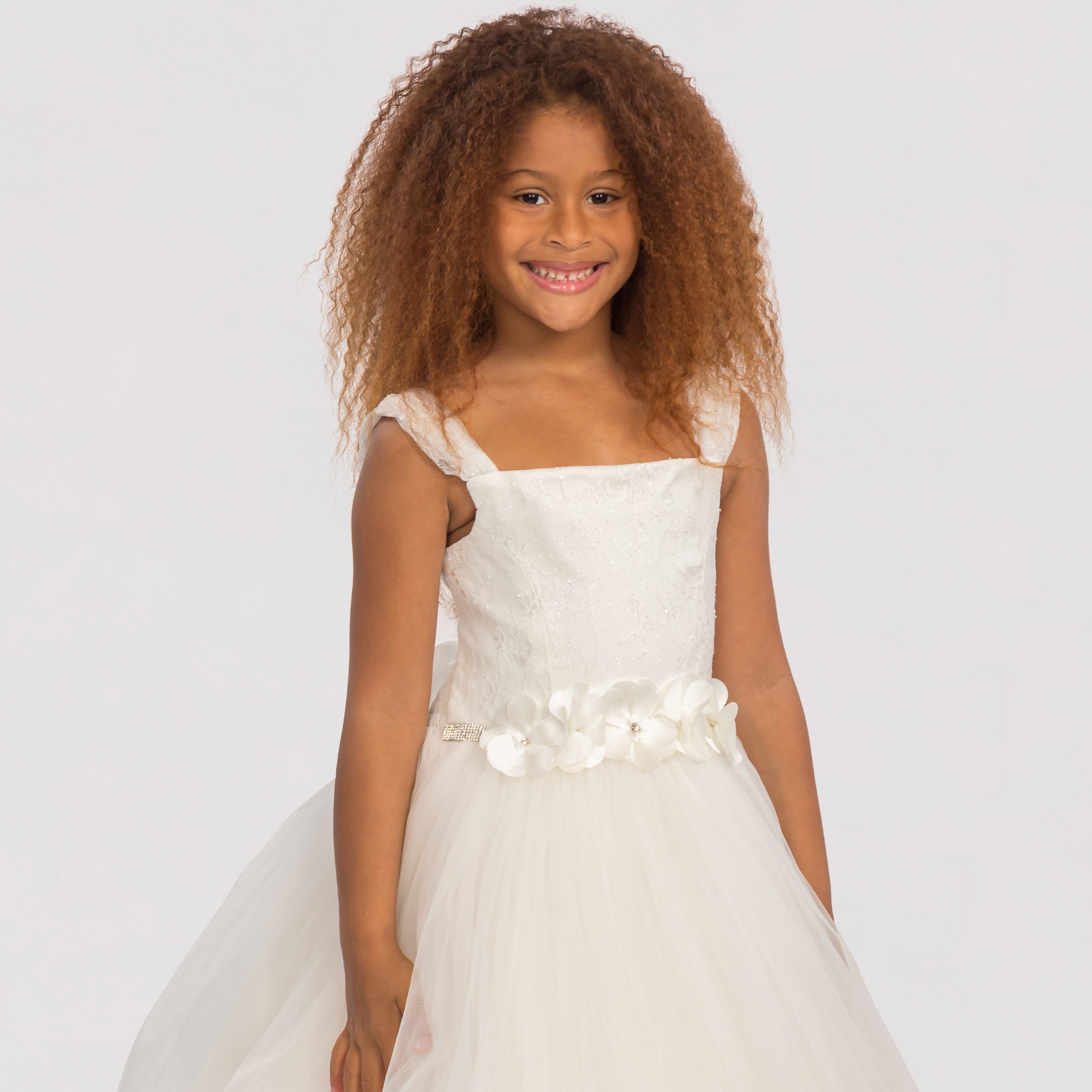 The Loveable Princess Girls Formal Dress features a white tulle skirt, floral belt, and delicate straps, perfect for special 