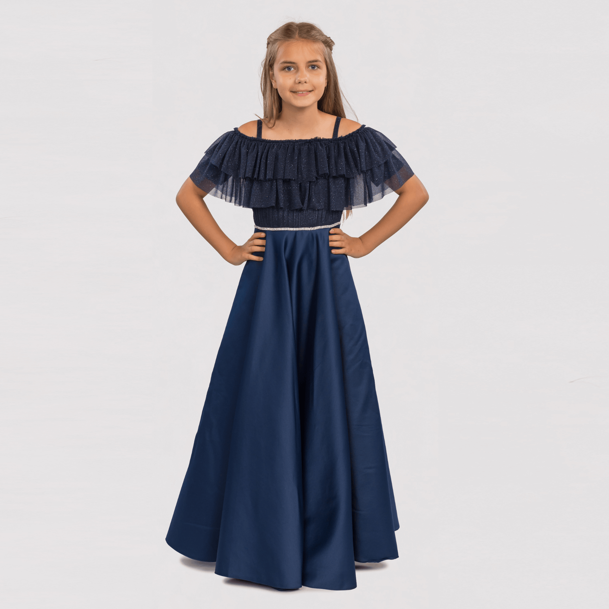 Emily's Gown Girls Formal Dress features a navy blue off-the-shoulder design with ruffled sleeves and a flowing skirt.