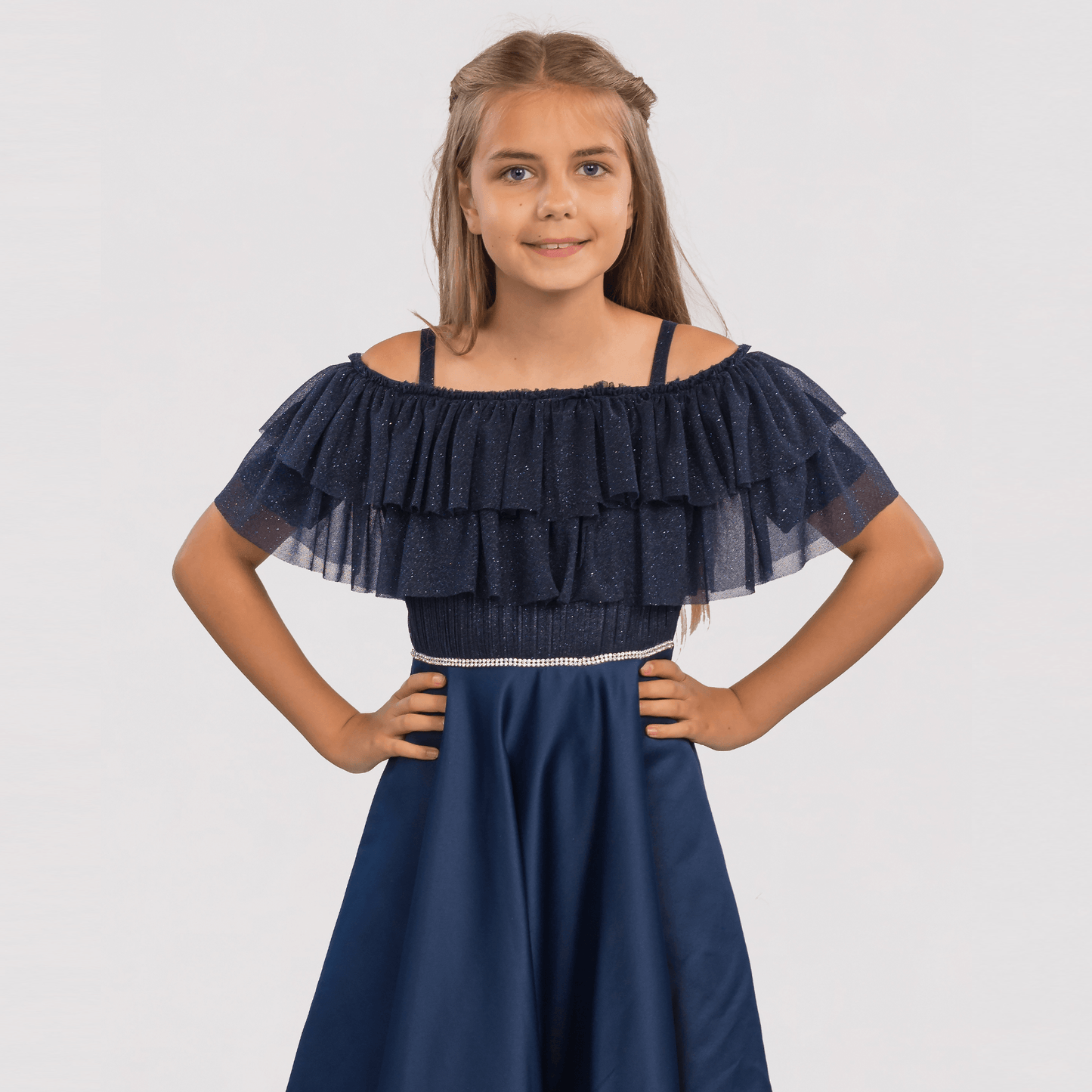 Emily's Gown Girls Formal Dress features a navy blue design with a ruffled off-shoulder top and a fitted waist.