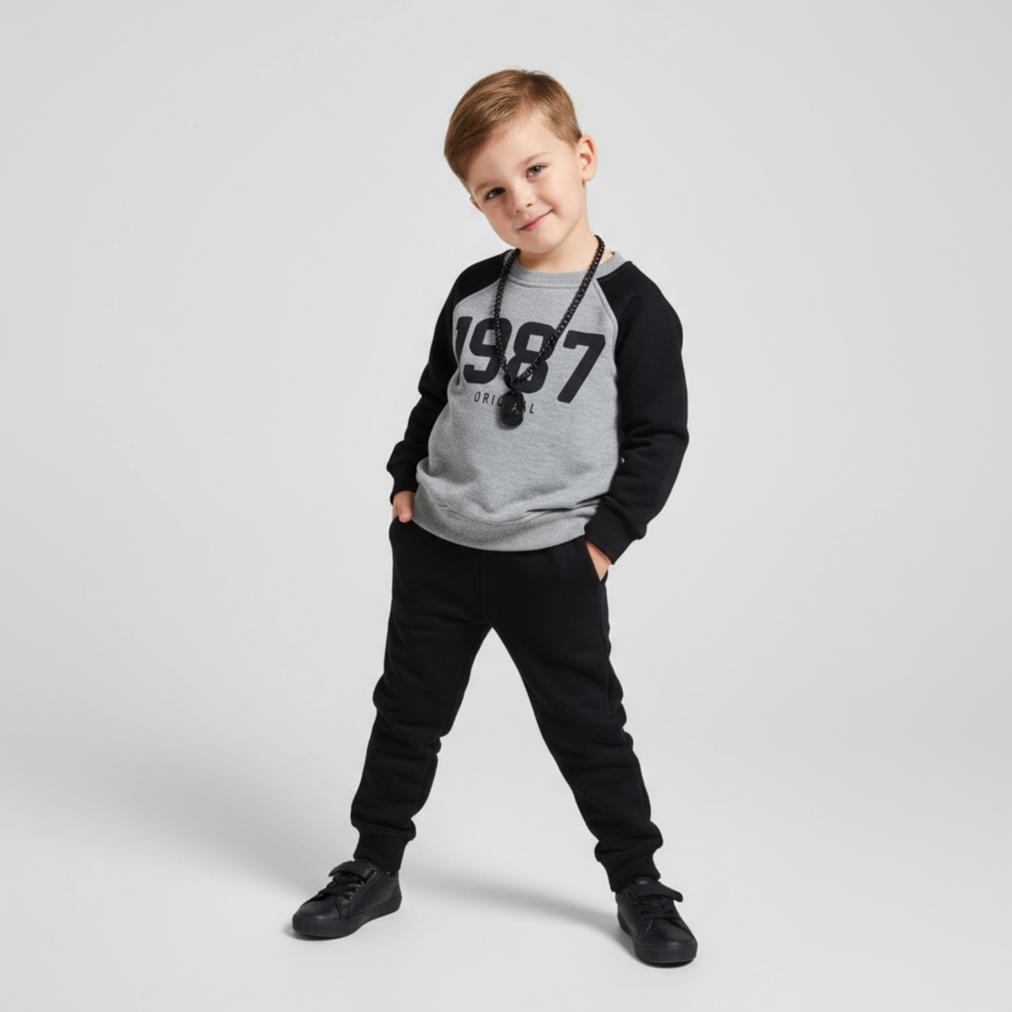 1987 Boys Joggers Set featuring a gray and black long-sleeve top with "1987" print and black joggers, styled with sneakers.