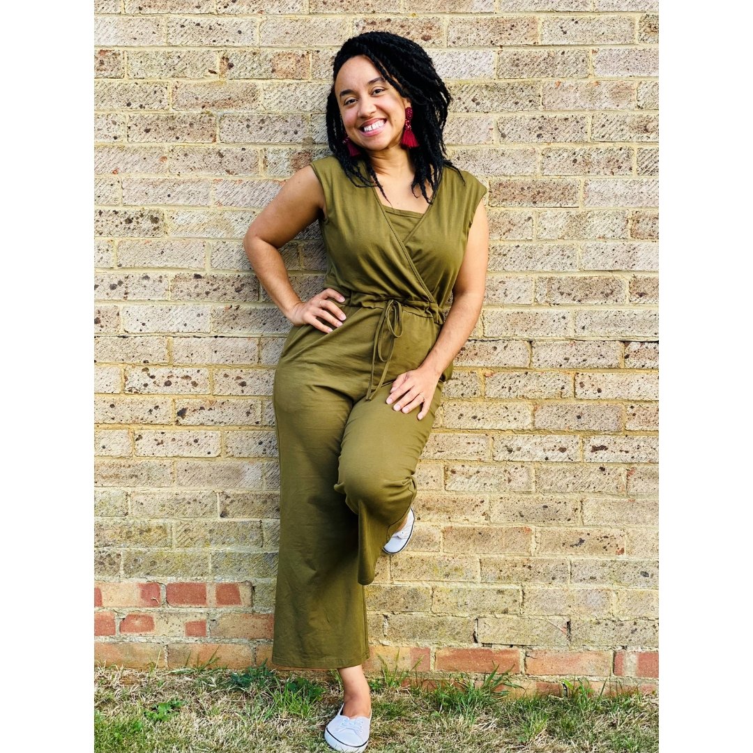 Breastfeeding Jumpsuit in Kerry Cotton Khaki, featuring a wrap design and tie waist, modeled against a brick wall.