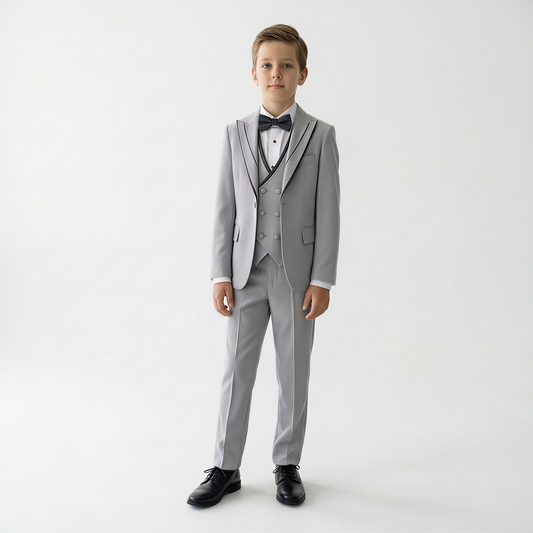 Boys Tuxedo in shades of grey featuring a double-breasted vest, bow tie, and black shoes, perfect for formal occasions.